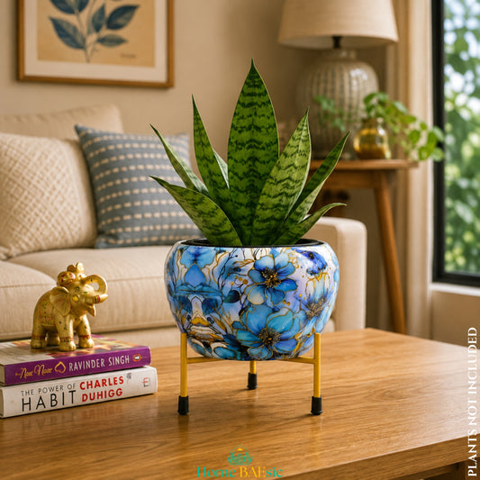 Azure blue floral metal planter with golden metal stand styled in a modern living room