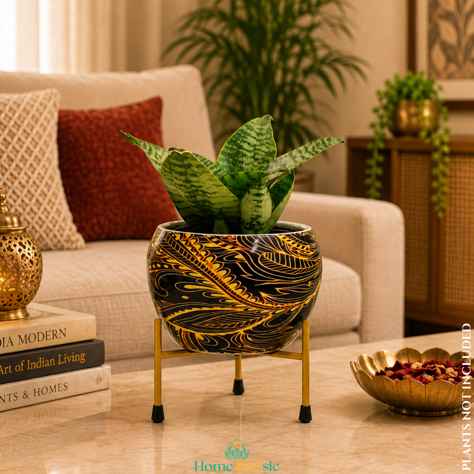 Black and golden abstract metal planter with green snake plant on a gold metal stand, styled in a modern home decor setting
