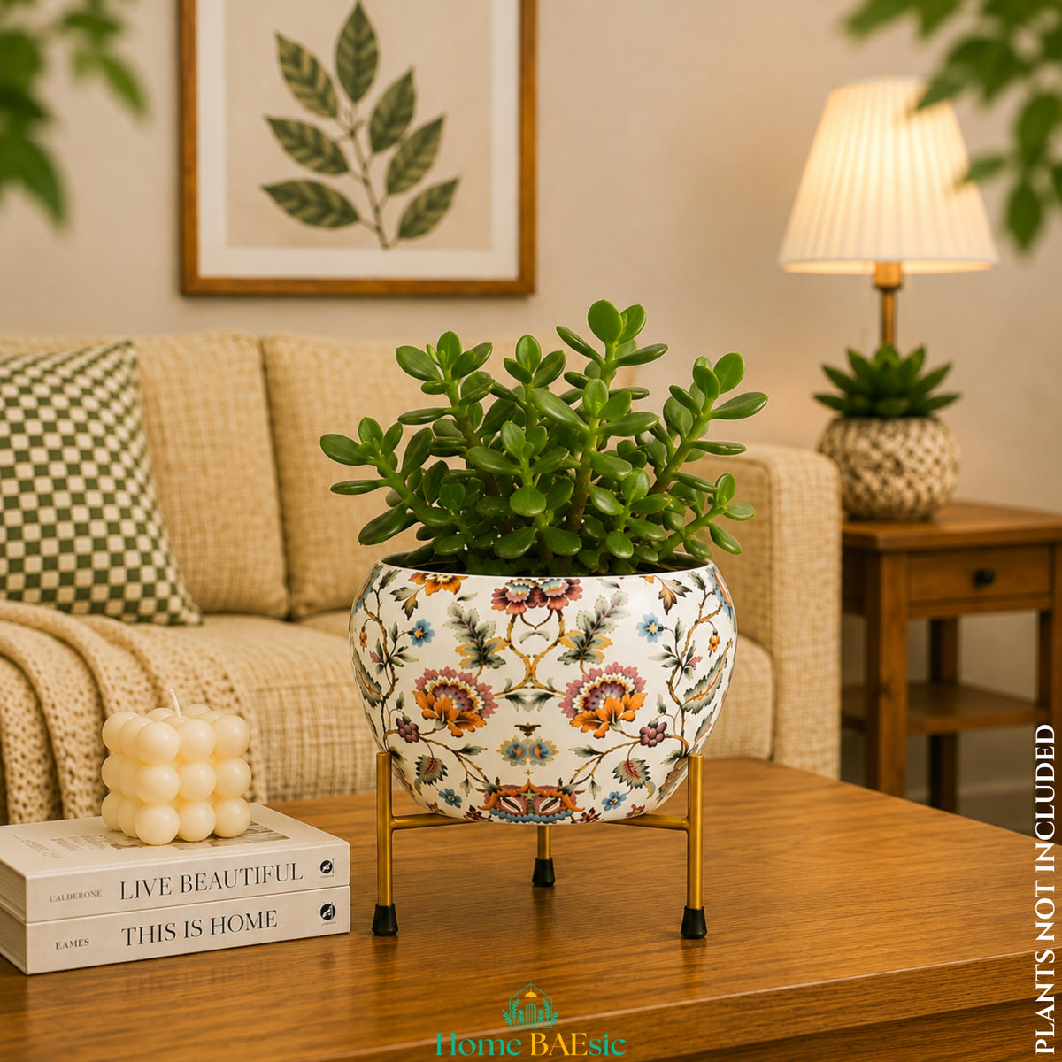 Blossom Paradise floral metal planter with lush jade plant on golden metal  stand in a warm modern living room on a wooden coffee table in a cozy living room setting.