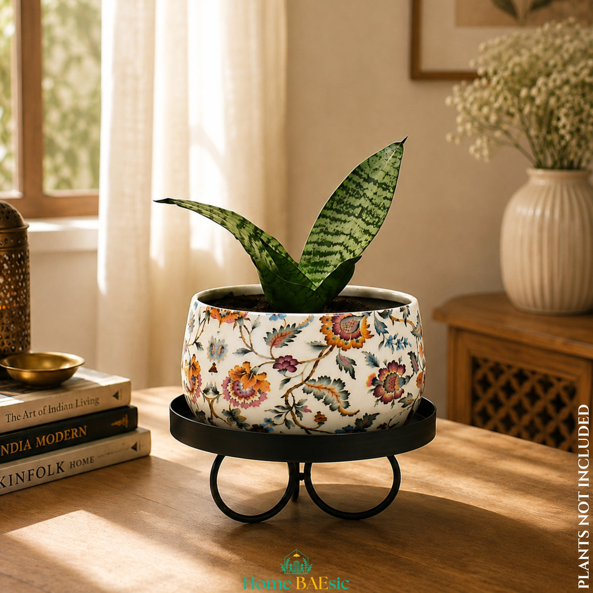 Blossom Paradise floral metal planter with snake plant on a tray stand in a modern living room