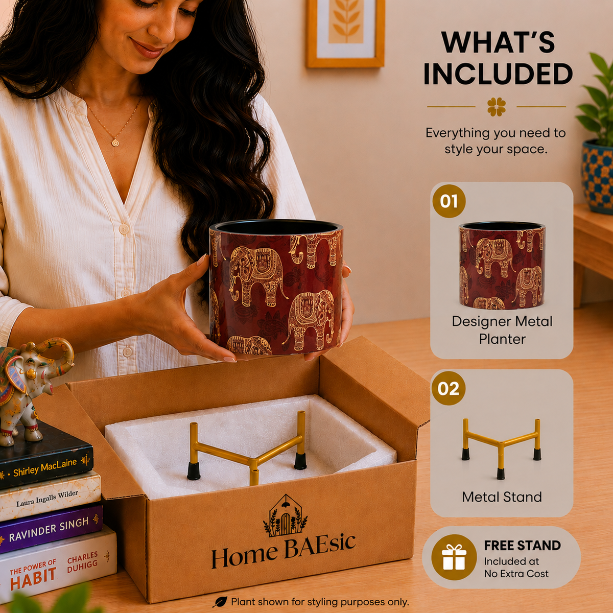 A woman holds a dark red metal planter with metal stand and gold elephant designs above an open cardboard box containing a gold metal stand, with a 'WHAT'S INCLUDED' infographic on the right.