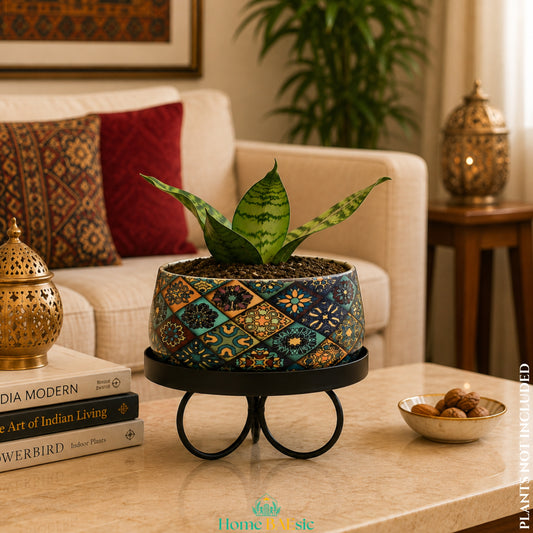 Floral Motif Tray Metal Planter with snake plant on black metal stand styled in a warm modern living room