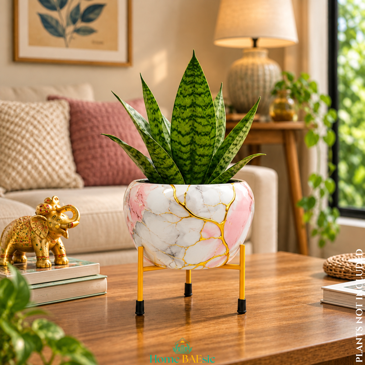 Golden Pink Marble designer planter with stand featuring elegant white and pink marble artwork with gold veining, styled with a green indoor plant as a premium home decor accent.