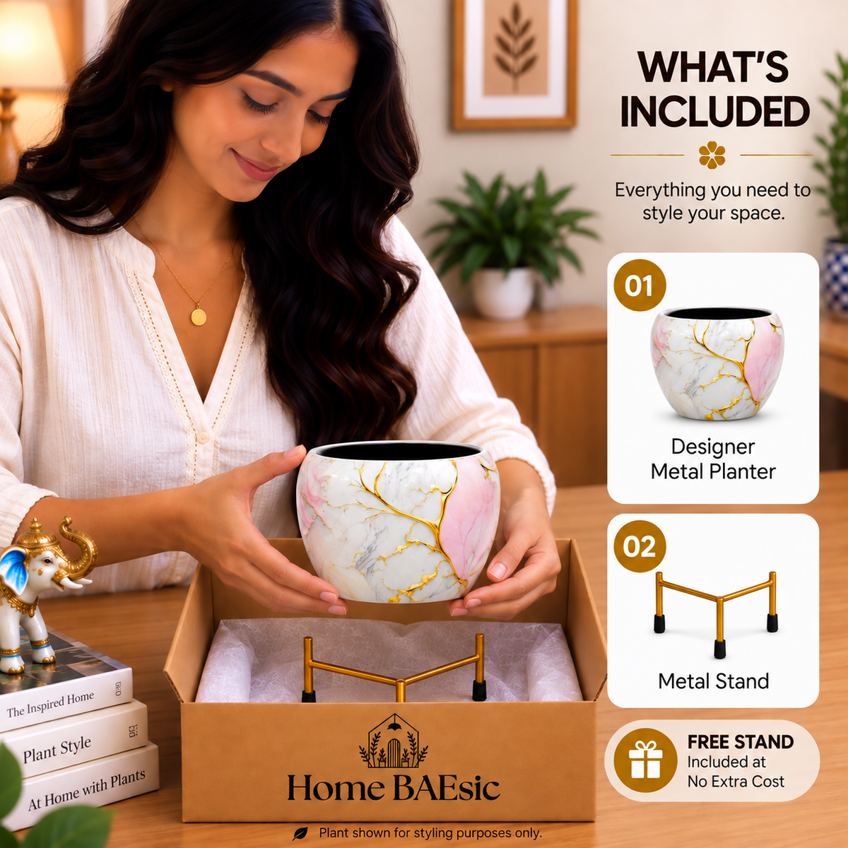 Home BAEsic Golden Pink Marble designer metal planter with gold stand shown in a stylish unboxing scene, with the planter held by a woman and displayed in the “What’s Included” callout alongside the included metal stand.