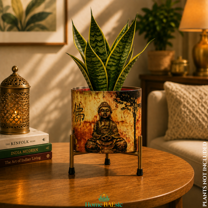 Meditating Buddha metal planter with a lush snake plant on a sturdy golden metal stand, styled as an elegant home decor accent