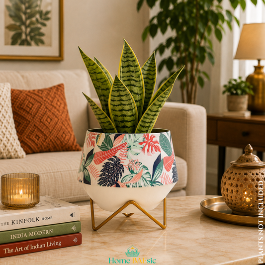 Monstera Magic designer metal planter with tropical leaf print and gold geometric stand, styled with a green indoor plant