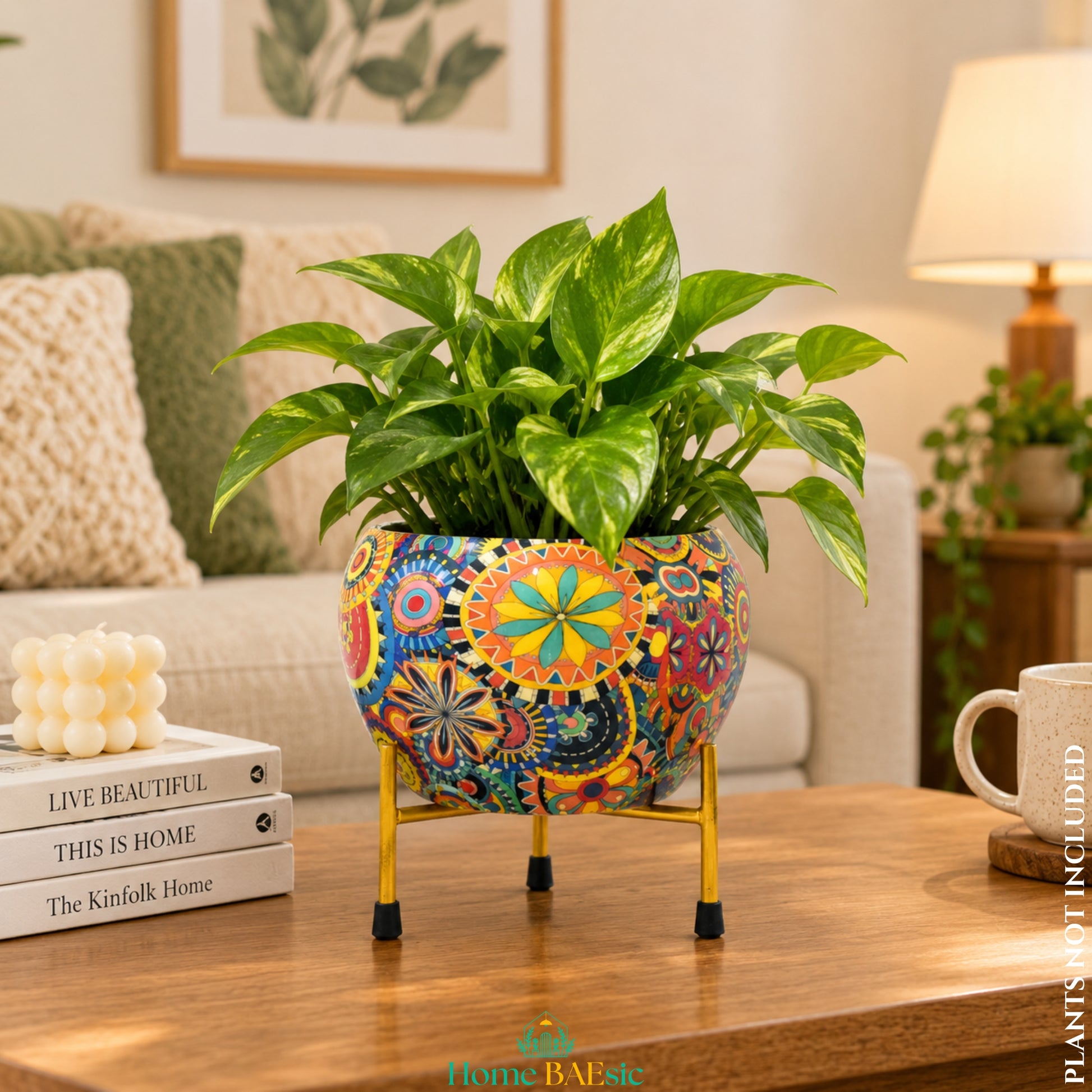 Multicolor Leaf metal planter with colorful floral and geometric design on gold stand, styled with indoor pothos plant and home decor