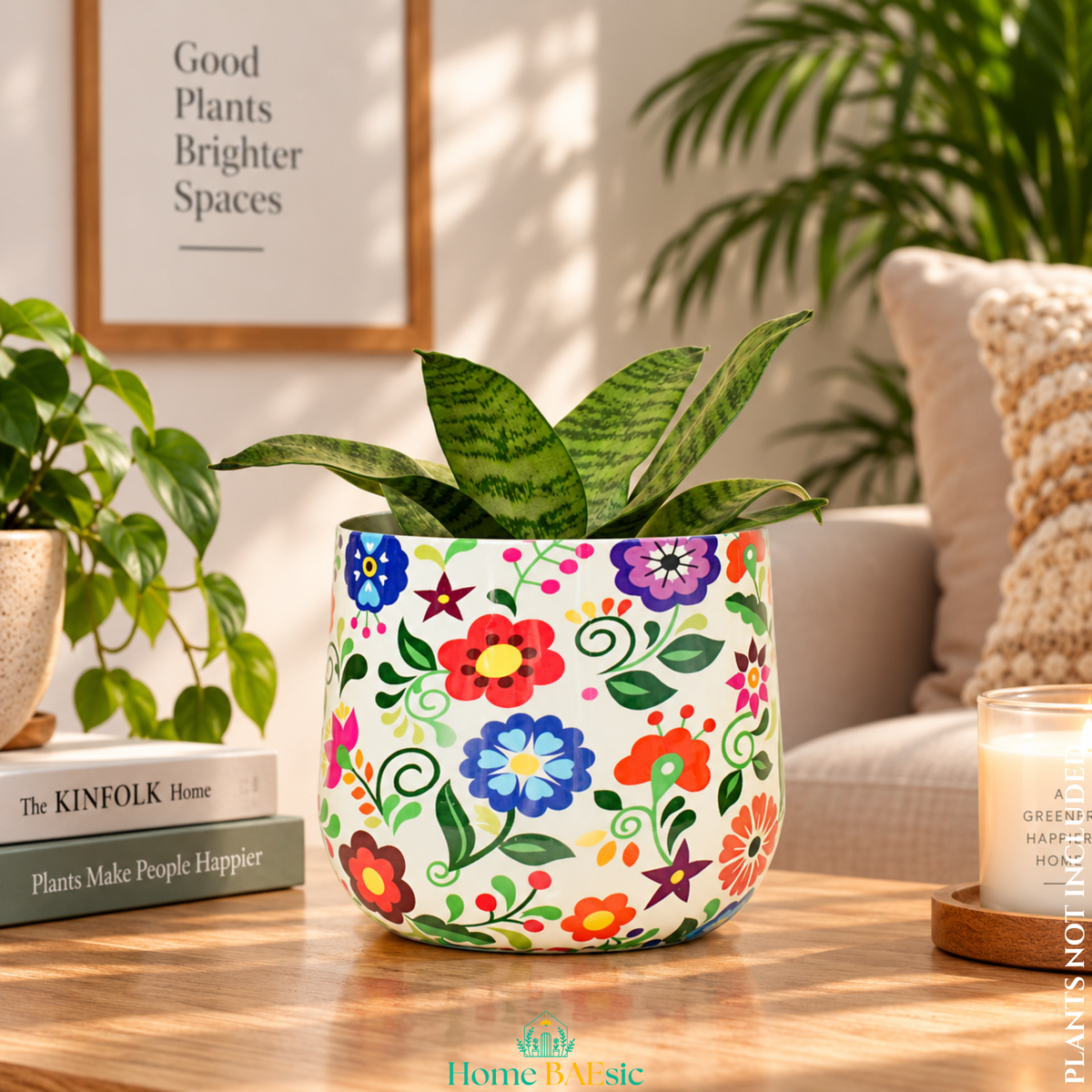 A Multifloral tumbler metal planter with colorful floral artwork and snake plant styled in a modern home. Colorful metal planter with a white base and a vibrant floral pattern, holding a green snake plant, set on a wooden table in a cozy living room environment.