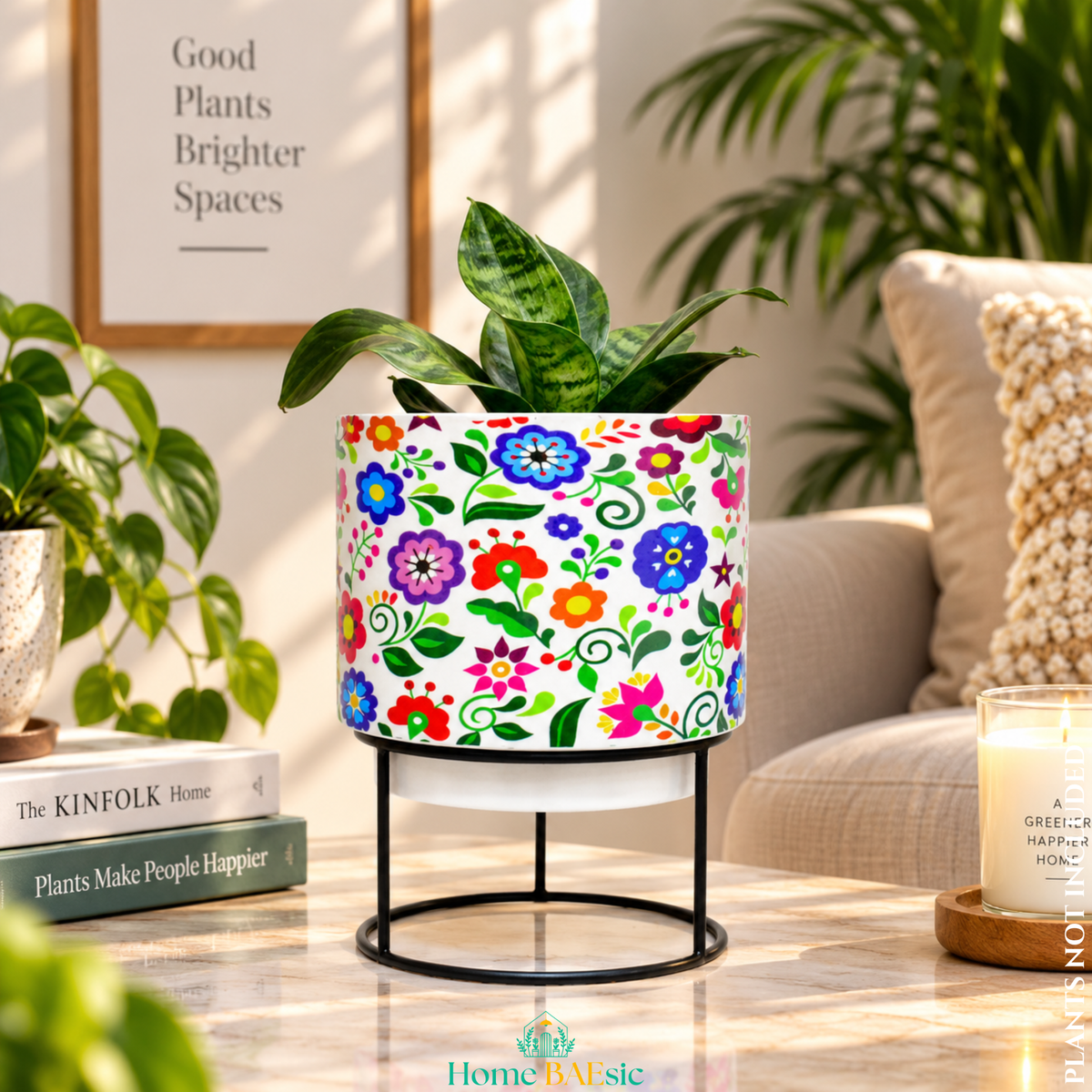 Multifloral designer metal tumbler planter with stand, featuring colorful floral artwork on a white background with a green indoor plant.