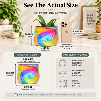 Home BAEsic Rainbow Breeze Tumbler planter actual size guide showing the colorful rainbow-patterned planter compared with an iPhone 15 Pro, with dimensions of 5.5-inch planter mouth, 6-inch maximum width, and 5-inch height; plants and decorative props not included, and no stand provided.