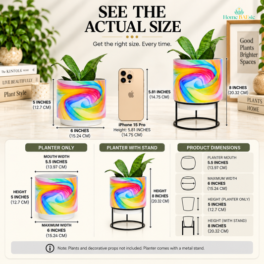 Home BAEsic Rainbow Breeze Tumbler Planter size guide showing the colorful rainbow swirl metal planter with and without its metal stand, compared with an iPhone 15 Pro. The infographic highlights a 5-inch planter height, 6-inch maximum width, 5.5-inch mouth width, and 8-inch height with stand, with product dimension callouts. Plants and decorative props are not included; the planter comes with a metal stand.