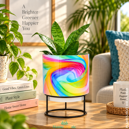Rainbow Breeze designer metal tumbler planter with stand, featuring vibrant multicolor swirling artwork in pink, blue, yellow, green and purple with a green indoor plant.