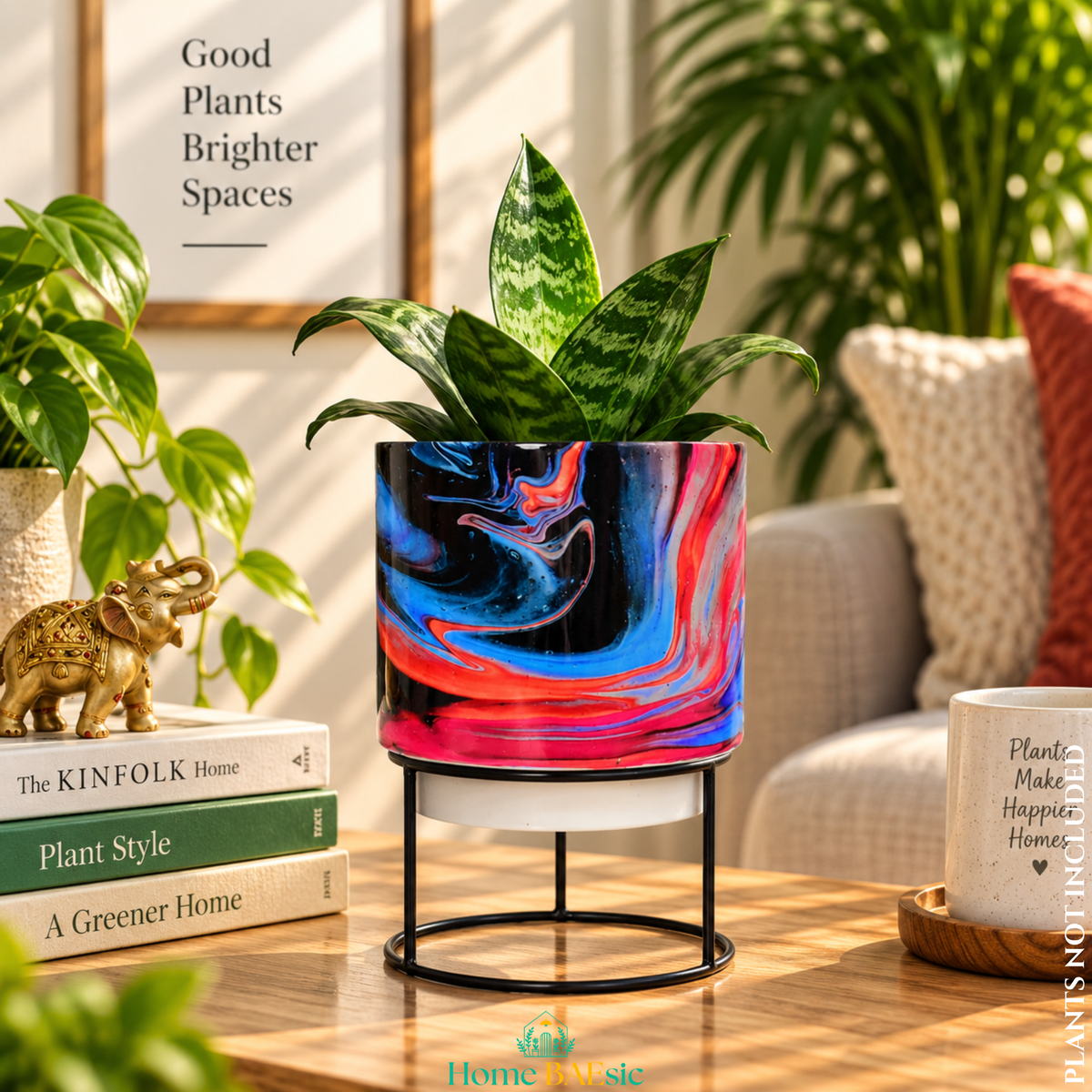 Rosso Storm designer metal tumbler planter with stand, featuring bold black, red, pink and blue marbled artwork with a green indoor plant.