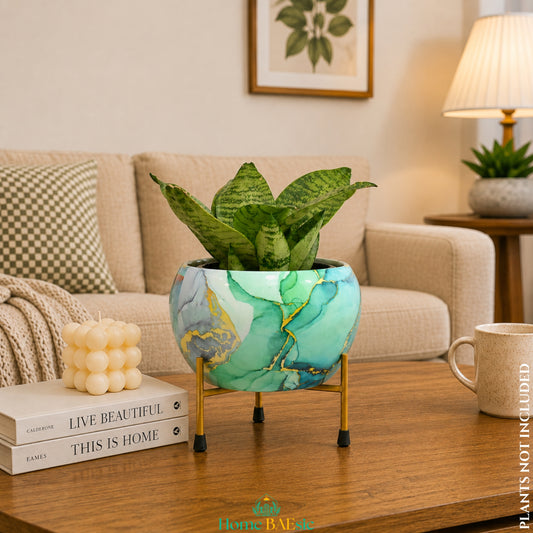 Turquoise Gold Planter with snake plant on a golden metal stand styled on a wooden table in a modern living room