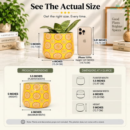 Home BAEsic Yellow Mandala Tumbler planter actual size guide showing the yellow and pink mandala-patterned planter compared with an iPhone 15 Pro, with a 5.5-inch planter mouth, 6-inch maximum width, and 5-inch height; plants, decorative props, and stand not included.