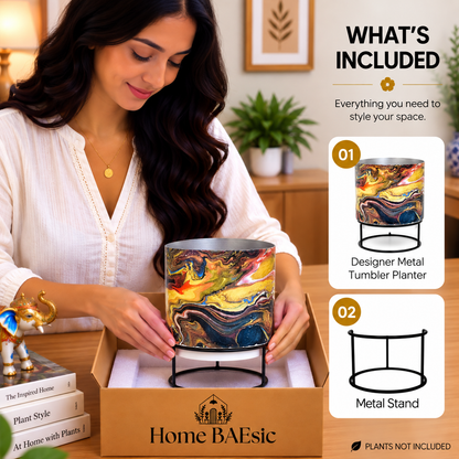Home BAEsic Zenia Storm tumbler planter with black metal stand, shown in a lifestyle unboxing scene with a woman holding the planter above its packaging and a “What’s Included” panel highlighting the designer metal tumbler planter and stand.